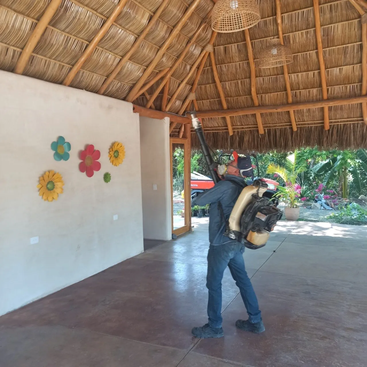 Técnico de El Astillero fumigando el área exterior de una casa